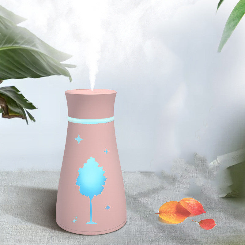 Pink humidifier with tree design on a light background