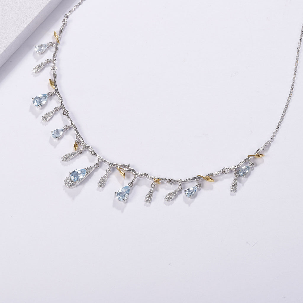 Delicate necklace with gemstones on a light gray background