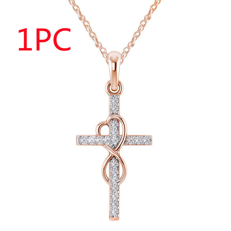 Rose gold cross pendant necklace with heart design on a white background