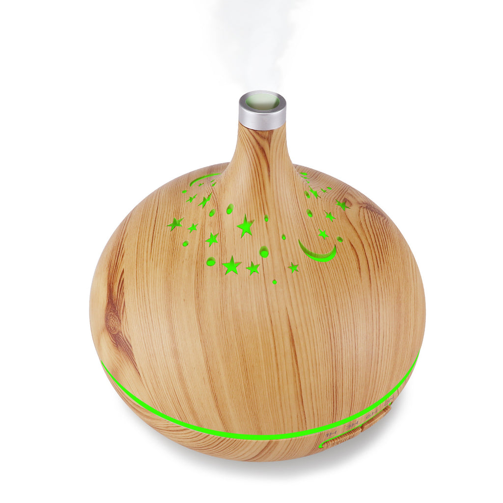 Wooden diffuser with green accents on a white background