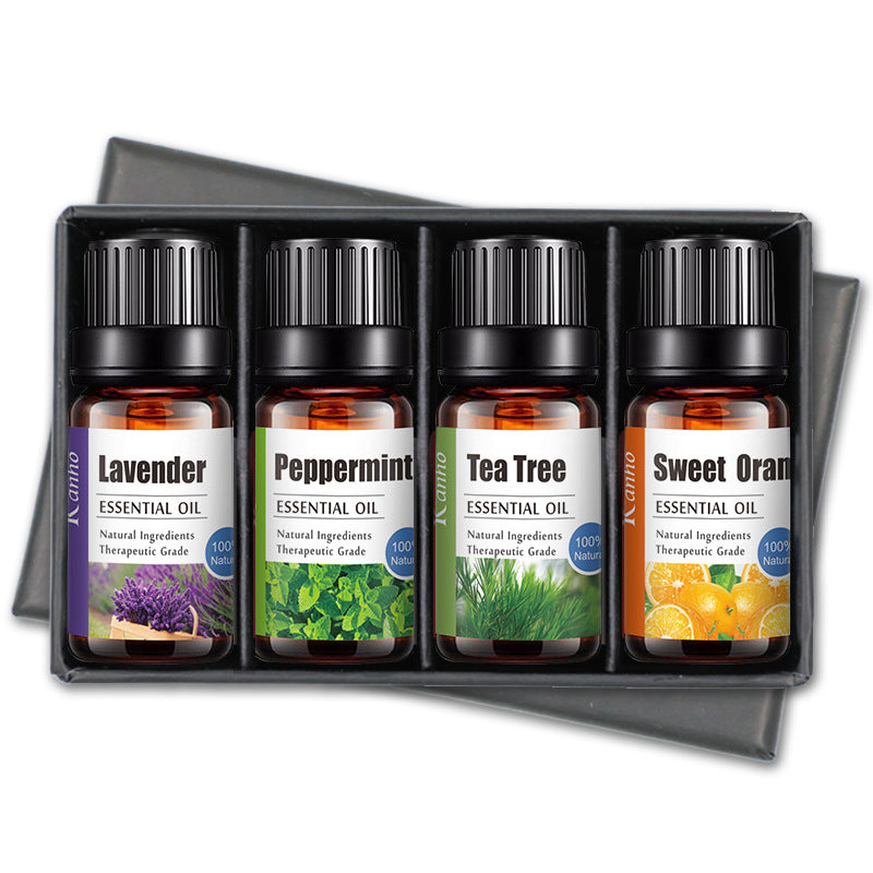Set of four essential oil bottles labeled Lavender, Peppermint, Tea Tree, and Sweet Orange in a black box.