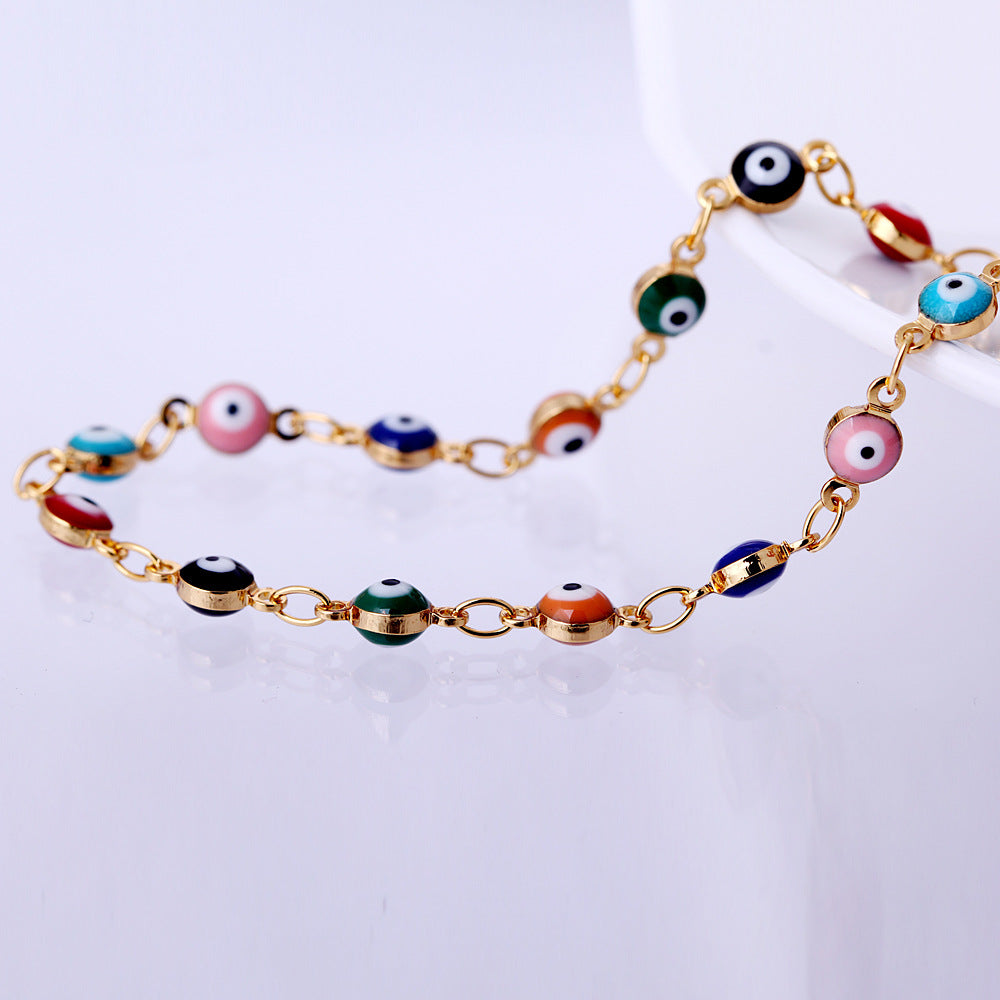 Bracelet with colorful eye-shaped beads on a light background