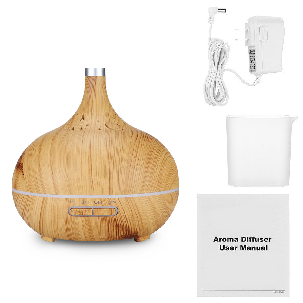 Wooden aroma diffuser with power adapter, water tank, and user manual on a white background