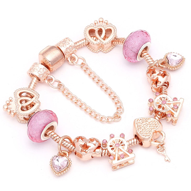 Rose gold charm bracelet with heart-shaped charms on a white background