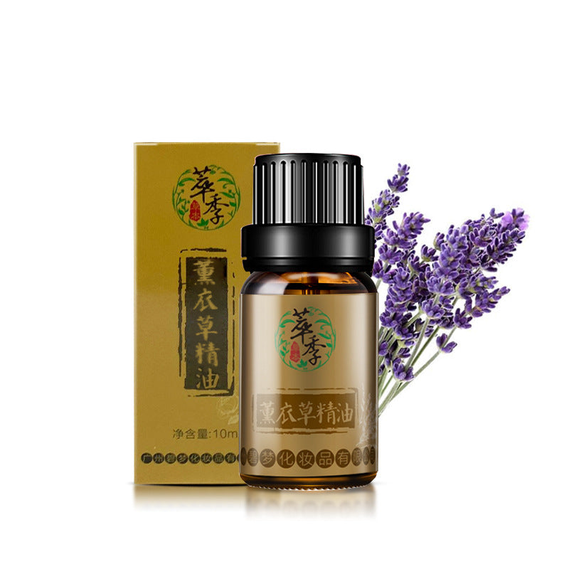 A bottle of essential oil with a black cap and a box on a white background, accompanied by lavender flowers.