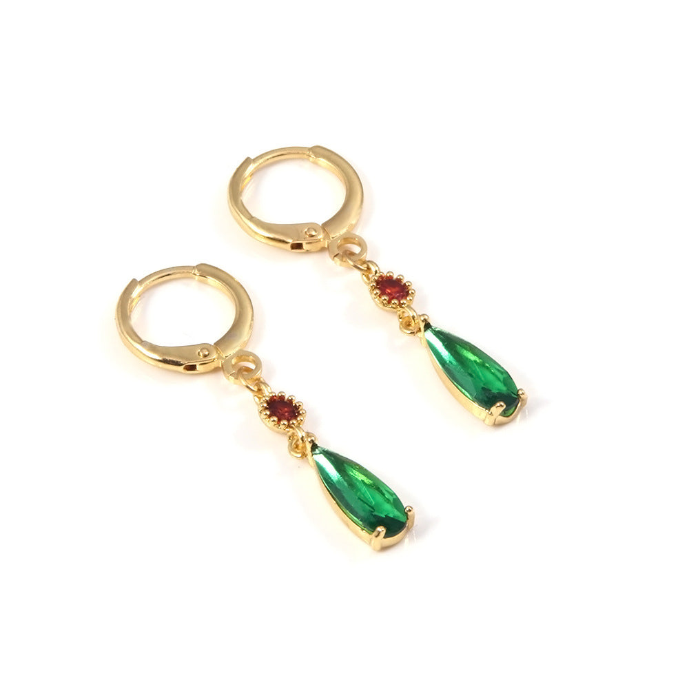 Gold hoop earrings with green teardrop-shaped gemstones on a white background