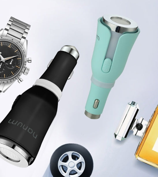 Collection of various items including a watch, car charger, and perfume bottle on a light gray background.