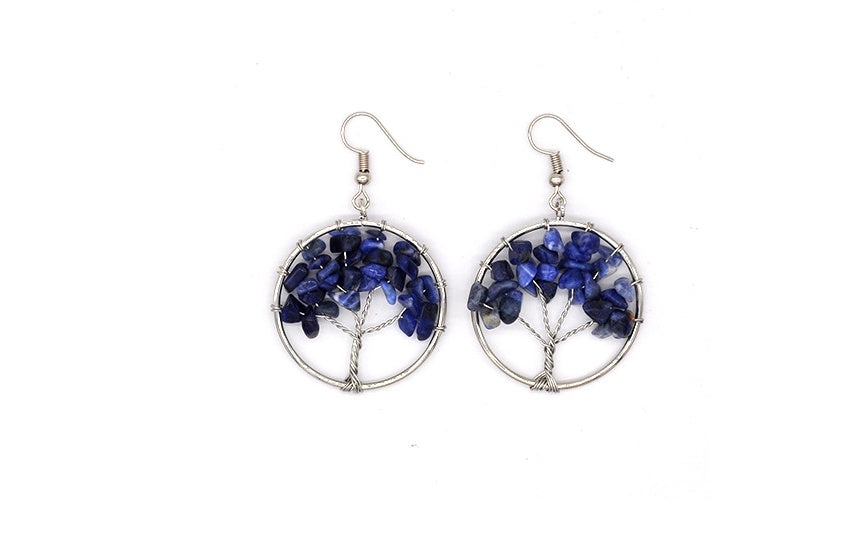 Tree-shaped earrings with blue stones on a white background