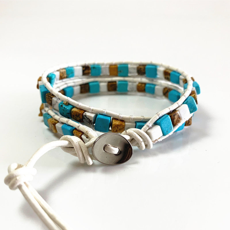 Multistrand beaded bracelet with a button clasp on a white background