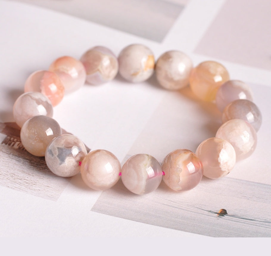 Necklace with peach-colored beads on a white surface