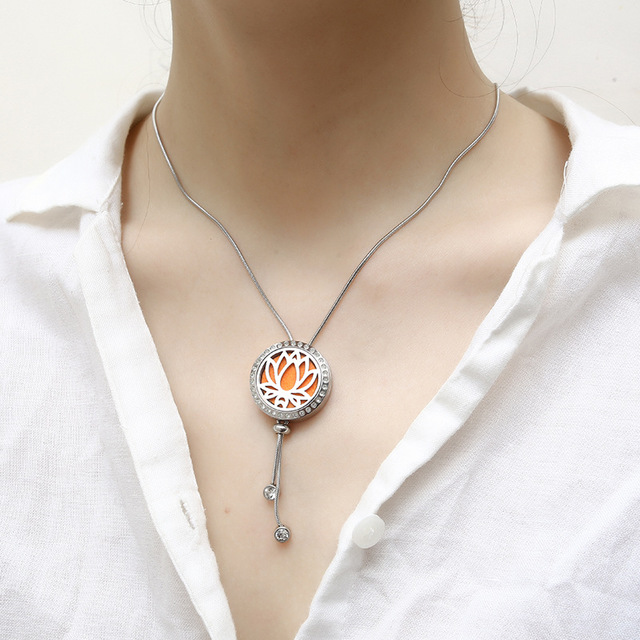Necklace with a circular pendant on a mannequin wearing a white shirt.