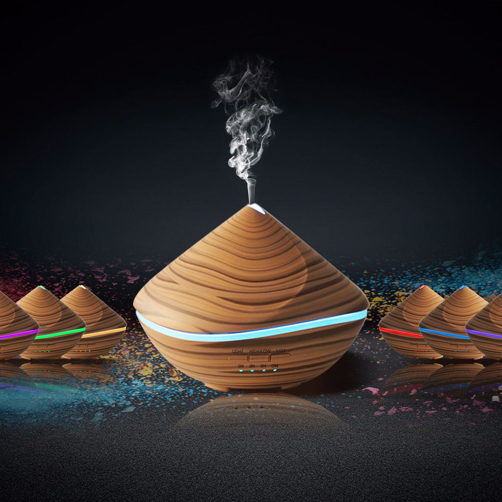 Wooden diffuser emitting steam on a dark background with colorful lights.