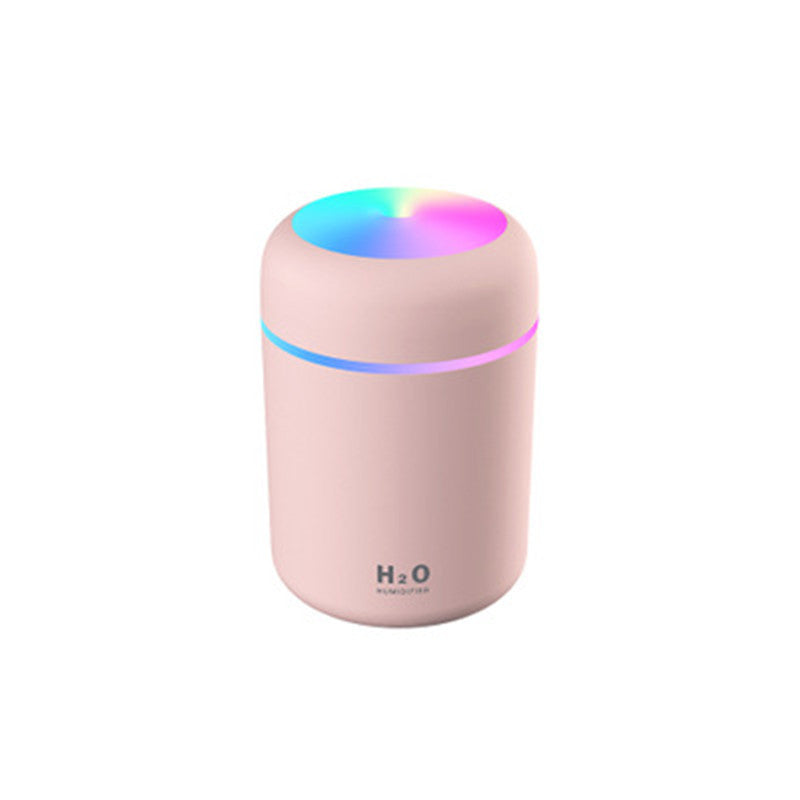 Pink humidifier with colorful light on a white background