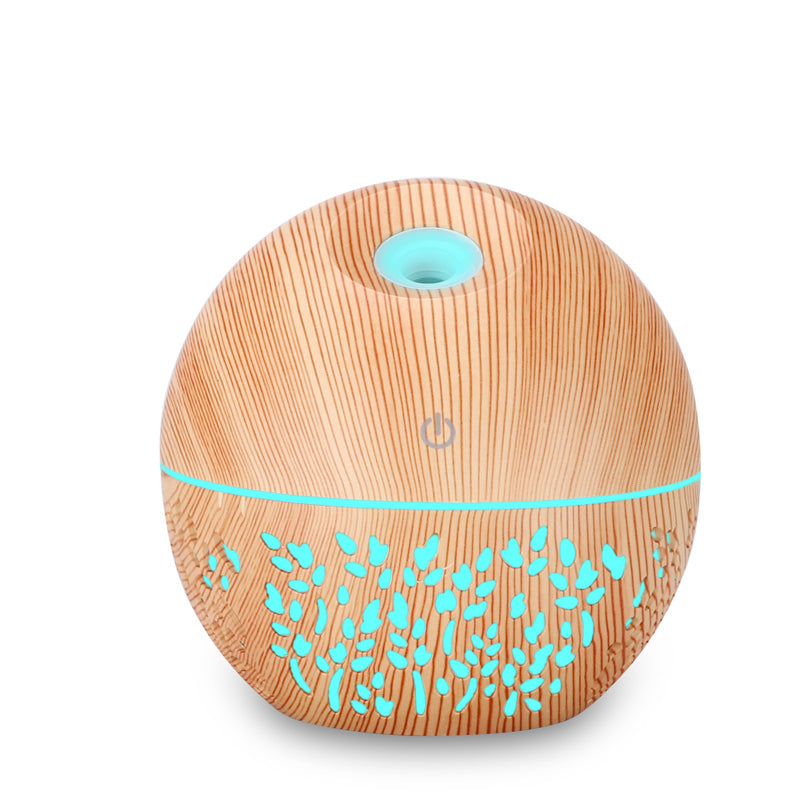 Wooden diffuser with teal design and lighting on a white background