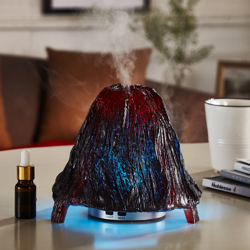 Volcanic-shaped humidifier emitting steam on a table with a blurred background