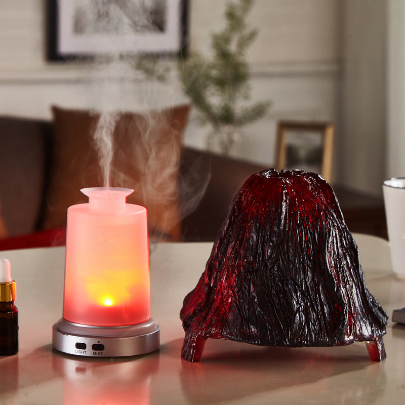 Vibrant red and black lava lamp on a table with a diffuser emitting steam in a cozy room.