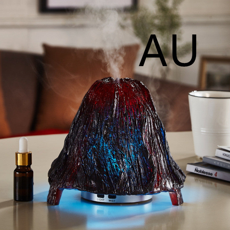 Volcano-shaped humidifier emitting steam on a table with a blurred background