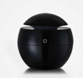 Black spherical device with a power symbol on a white background