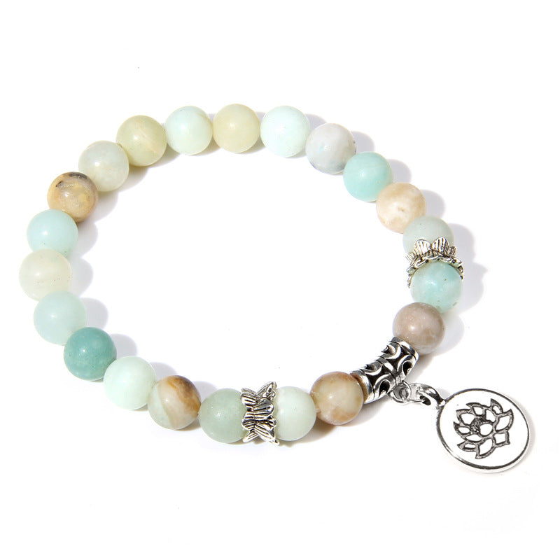 Beaded bracelet with a lotus charm on a white background