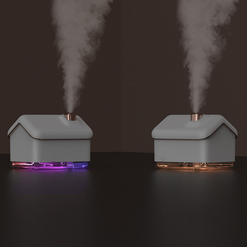 Two gray humidifiers emitting steam on a dark background