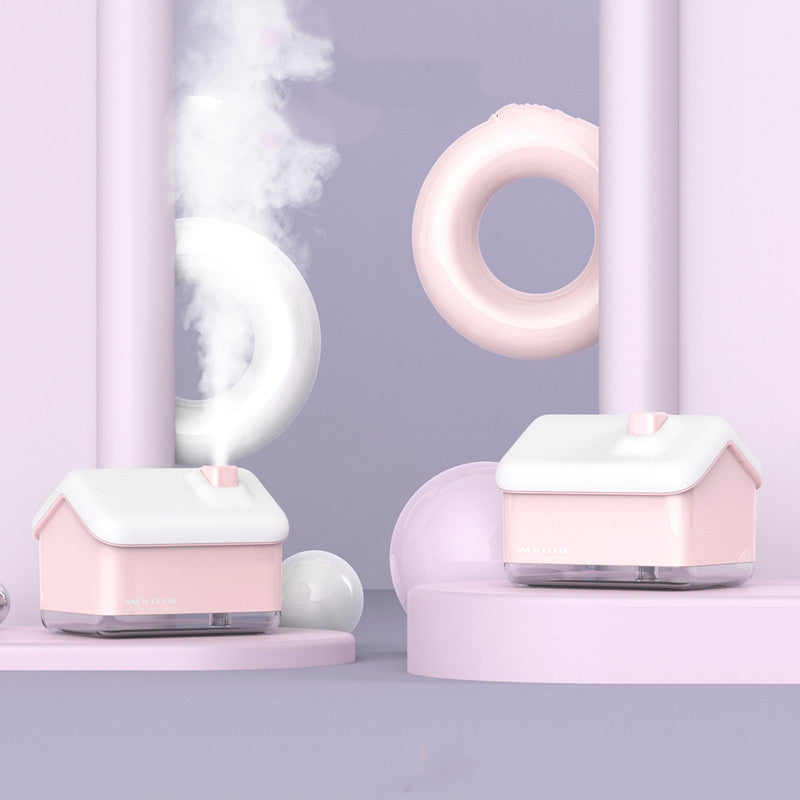 Pink humidifier emitting mist on a light purple background