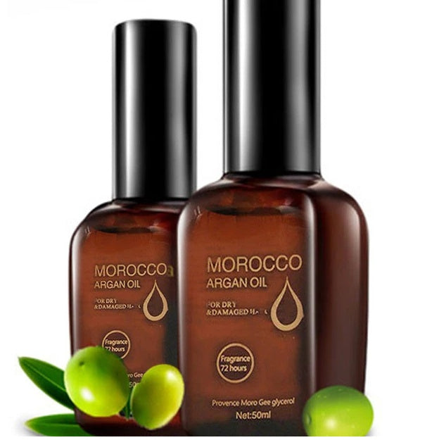 Two bottles of Morocco Argan Oil with green olives on a white background