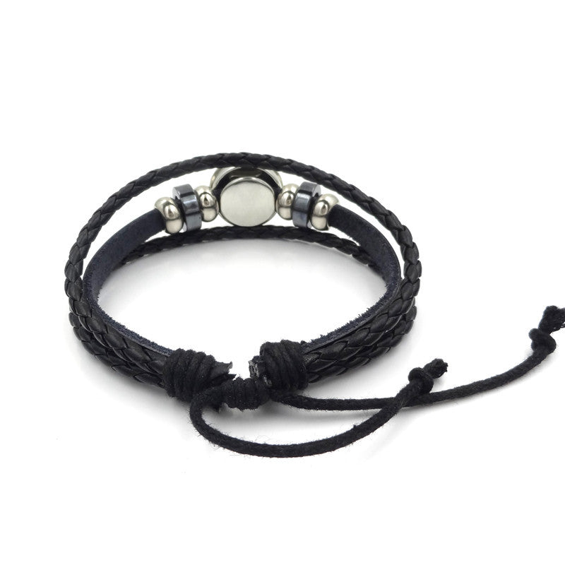 Black braided leather bracelet with silver beads on a white background