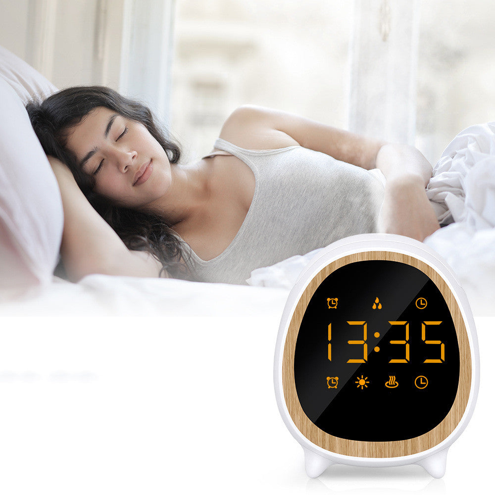 Woman sleeping in bed with a digital alarm clock showing the time.