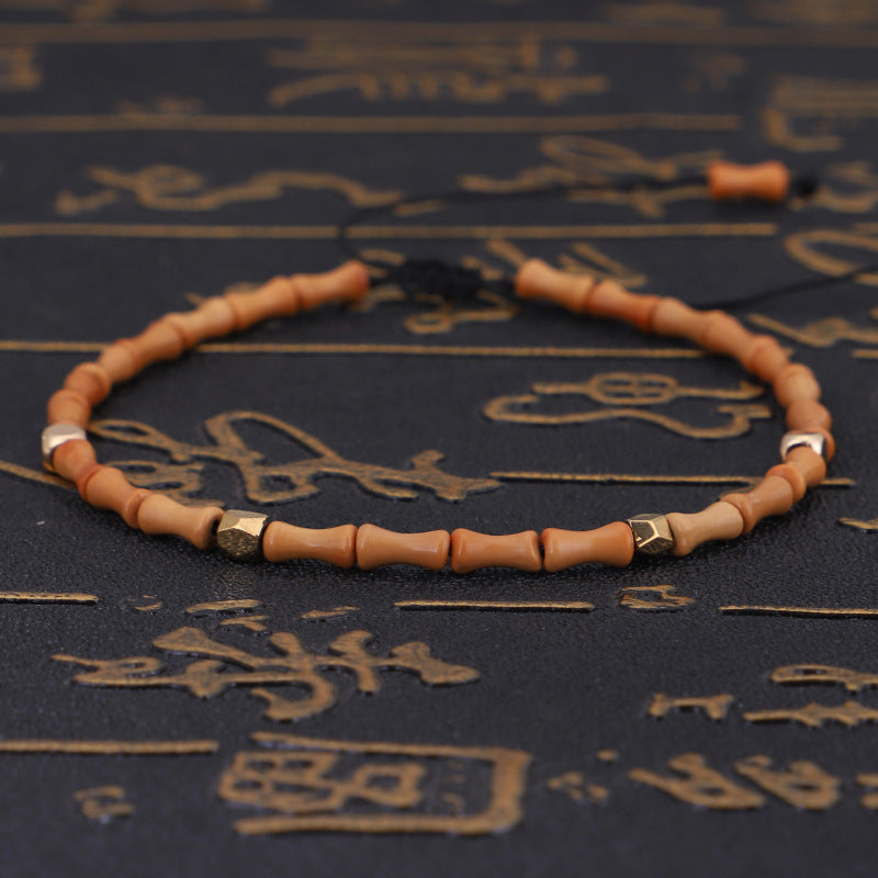 Beaded bracelet on a textured dark surface with Chinese characters