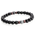 Black beaded bracelet with a few larger beads on a white background