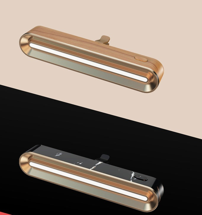 Two metallic light fixtures on a beige and black background