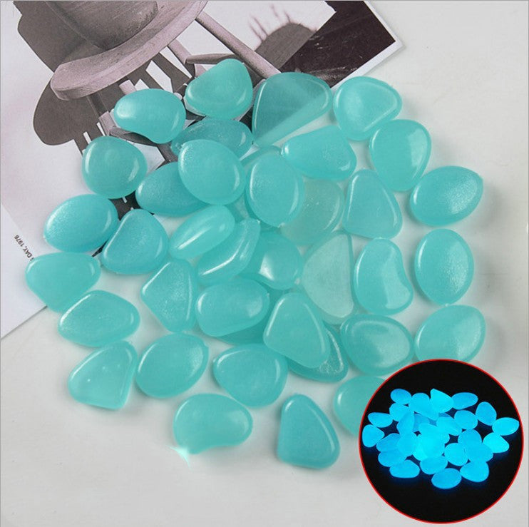 Turquoise stones on a white surface with a close-up inset showing their glow-in-the-dark property.