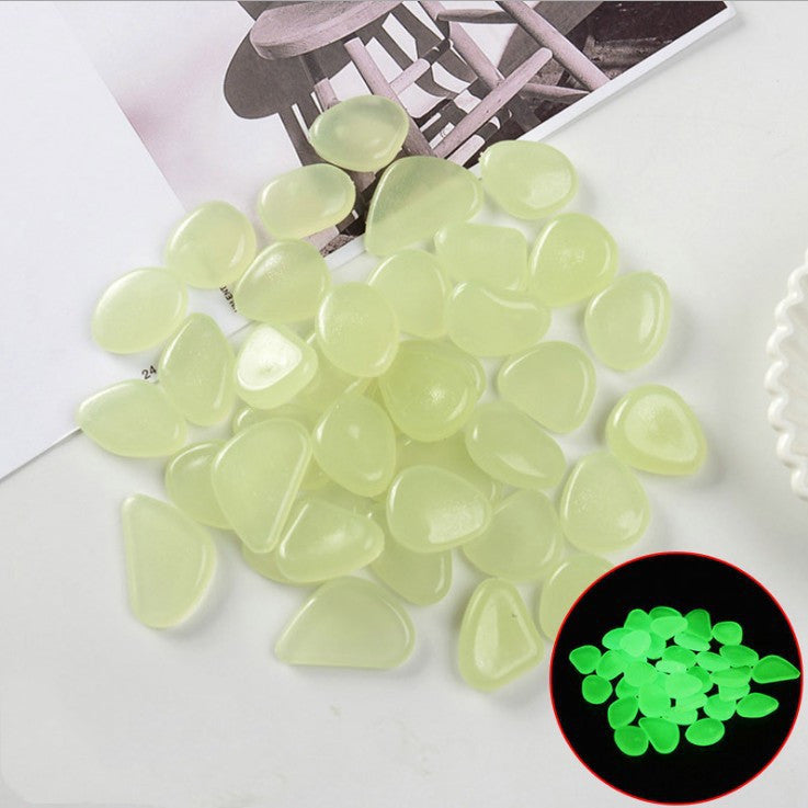 Glowing green stones on a white surface with a black and white chair in the background.