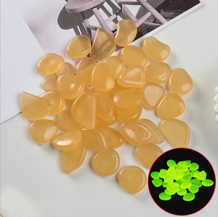 Yellow stones with a close-up inset showing their glow-in-the-dark property on a white surface.