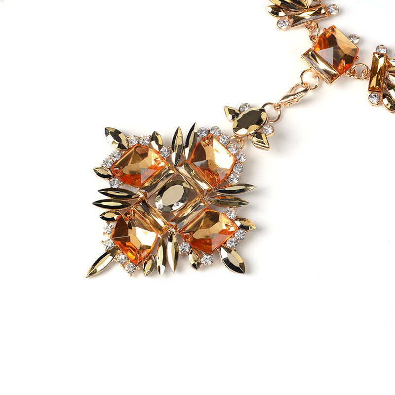 Elegant necklace with orange and gold gemstones on a white background