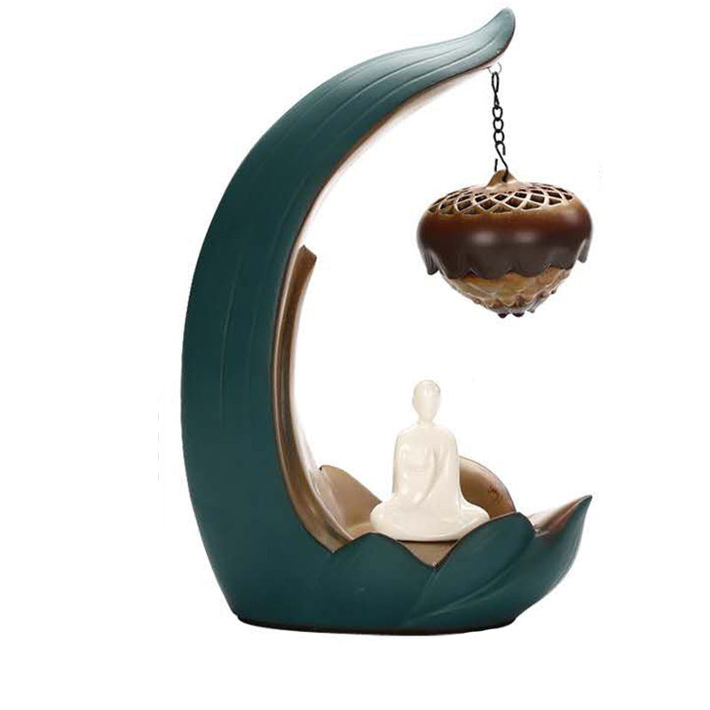 Decorative incense burner with a Buddha figure and hanging incense holder on a white background