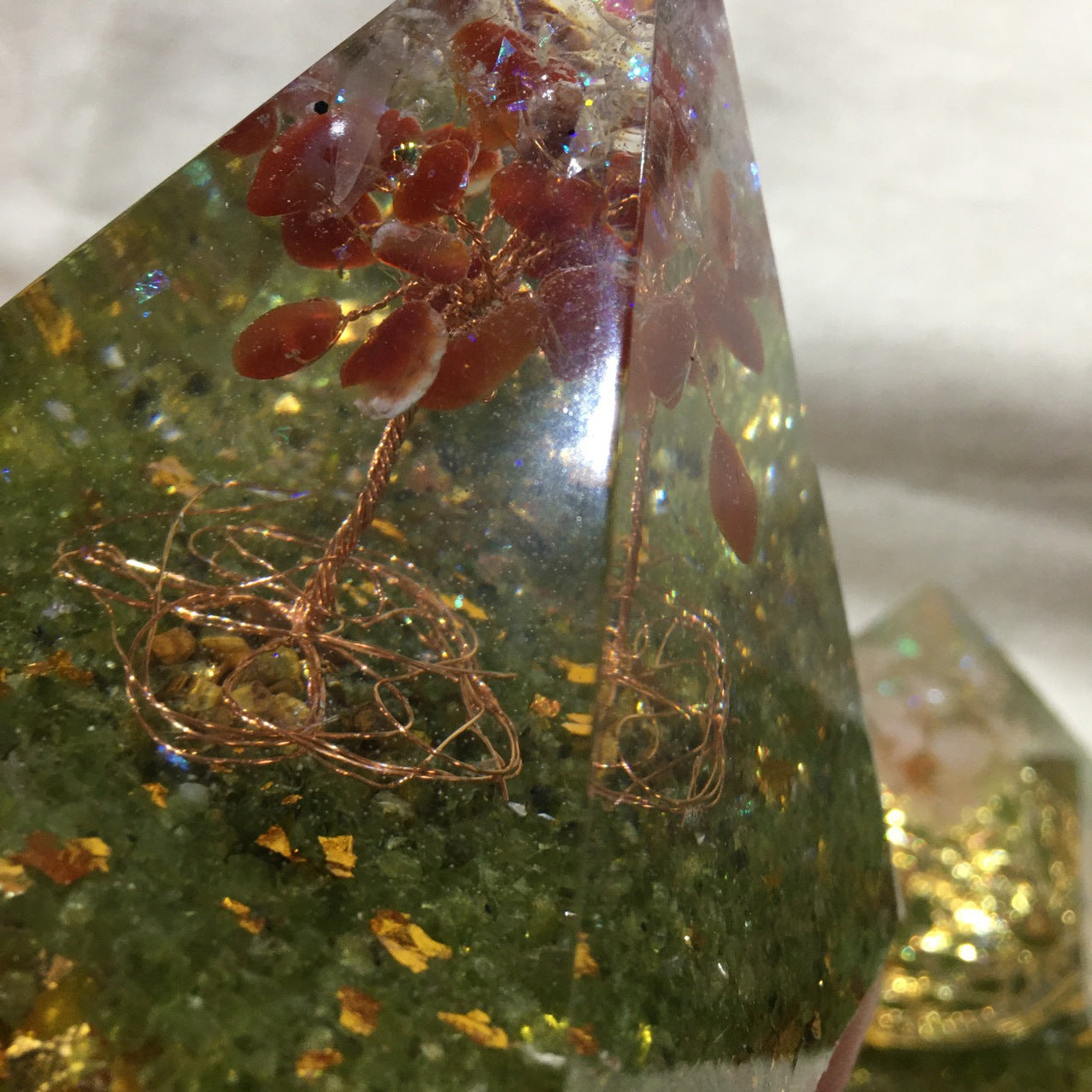 Decorative pyramid with red leaves and gold wire on a green base