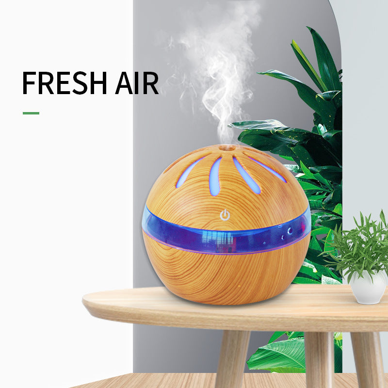 Wooden diffuser emitting steam with plants in the background, labeled 'Fresh Air'.