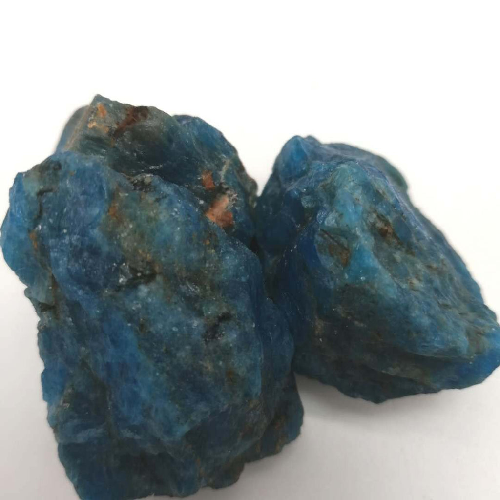 Two blue mineral rocks on a white background