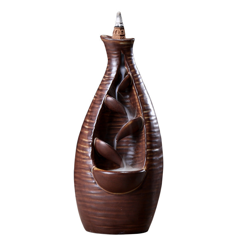 Decorative brown vase with a unique design on a white background