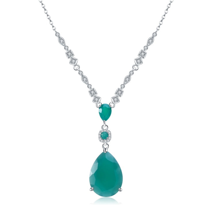 Necklace with green teardrop pendants and diamond-like accents on a white background