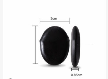 Black button with measurements on a white background