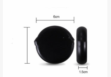 Black circular object with measurements on a white background