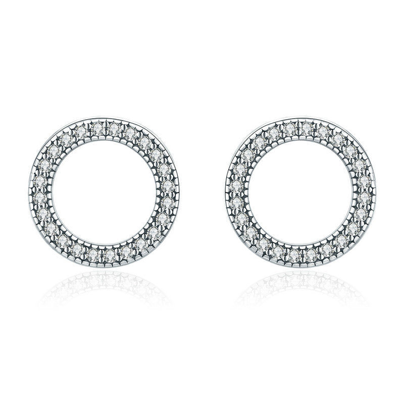 Pair of round earrings with diamond accents on a white background