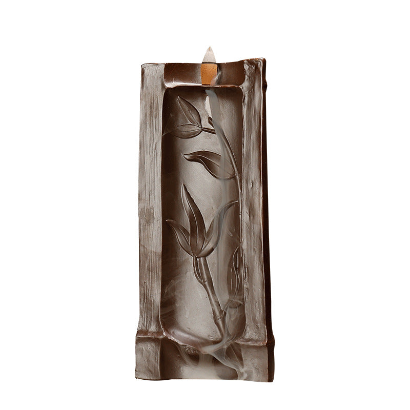 Decorative incent holder with leaf design on a white background