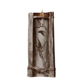 Decorative candle holder with leaf design on a white background