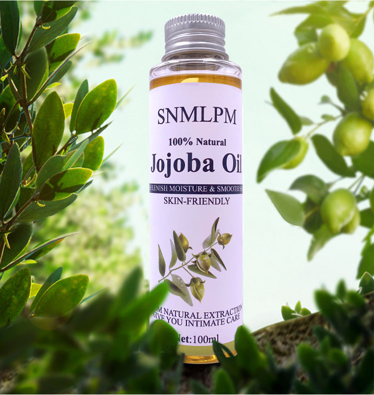 Jojoba oil bottle with plant background