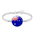 Silver bracelet with a round charm featuring the Australian flag on a white background