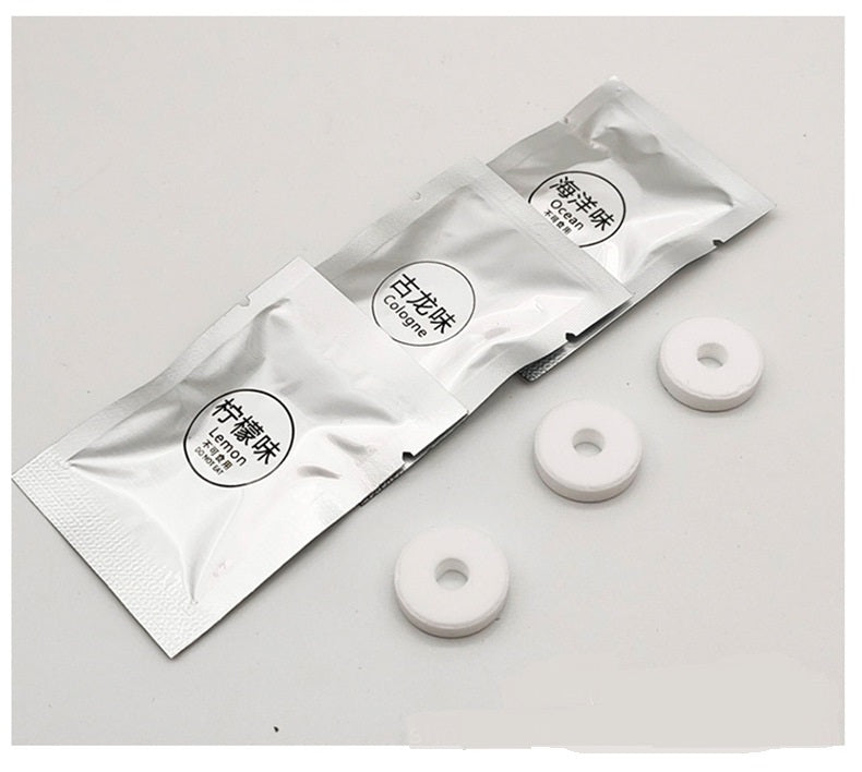 Three white circular objects and three silver packets with text on a light gray background