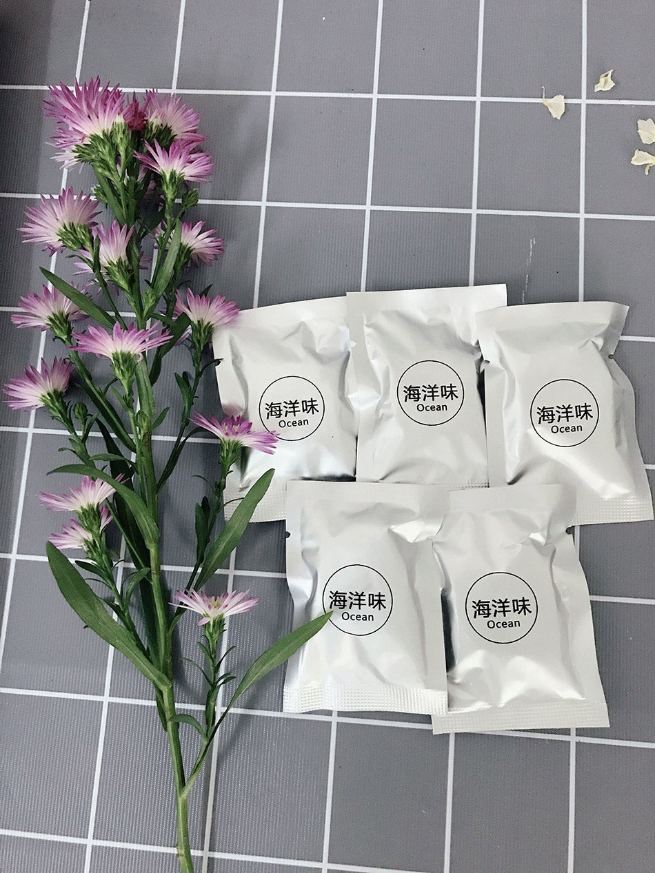Purple flowers with white packages labeled 'Ocean' on a checkered background